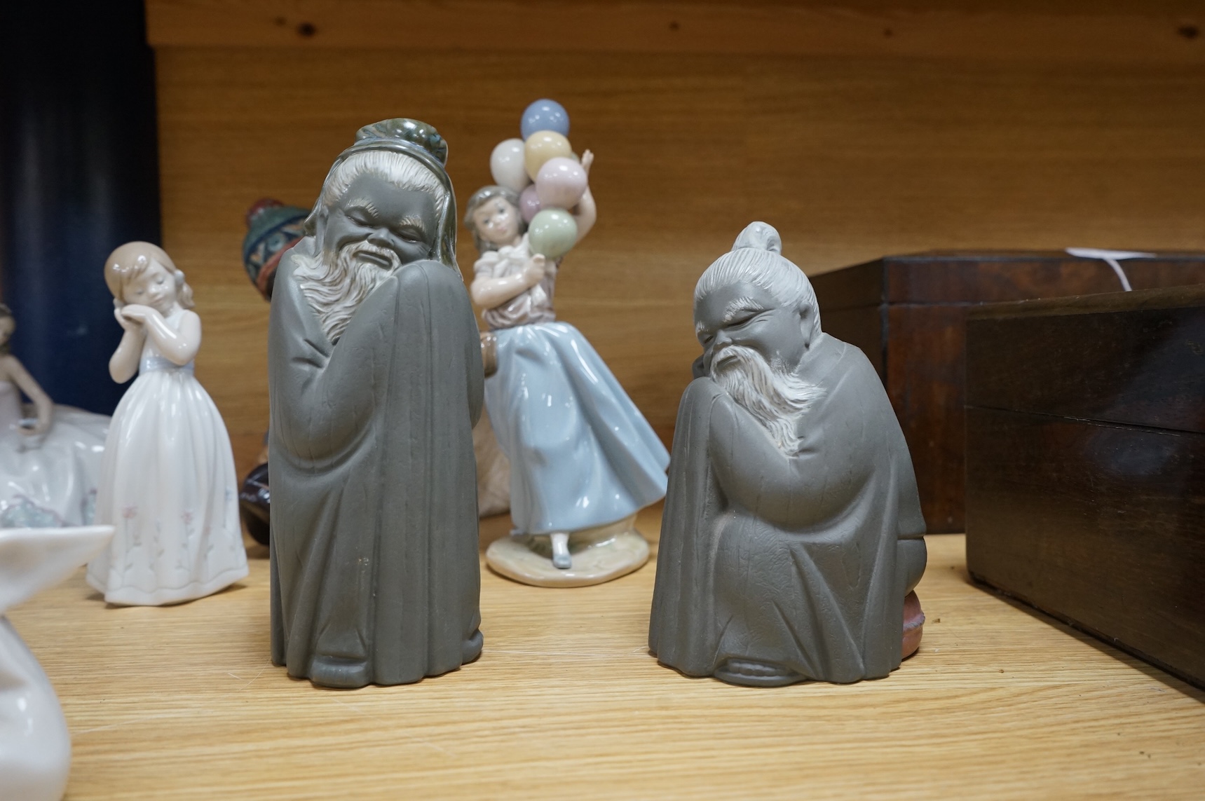 A collection of Lladro to including an eskimo and polar bear group, 23cm high (9)